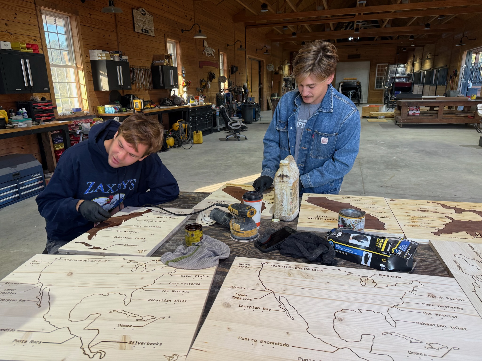 Two of us staining a batch of maps in the workshop.